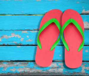 Colorful flip flops arranged on a surface, representing the casual summer footwear choice.