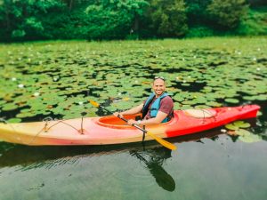 a man in a kayak on a lake