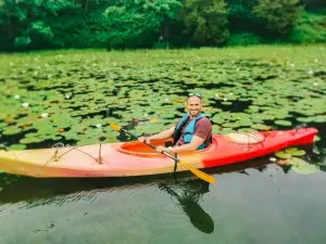 a man in a kayak on a lake