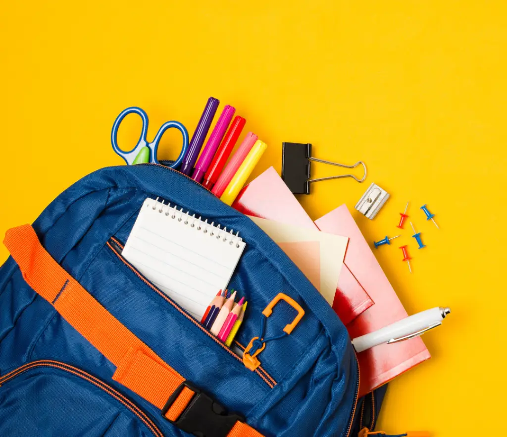 7 Essential Backpack Safety Tips: Protect Your Kids' Spine with Expert Advice from a Chiropractor in London Ontario 2 Blue backpack overflowing with school supplies on a bright yellow background, illustrating important backpack safety tips.