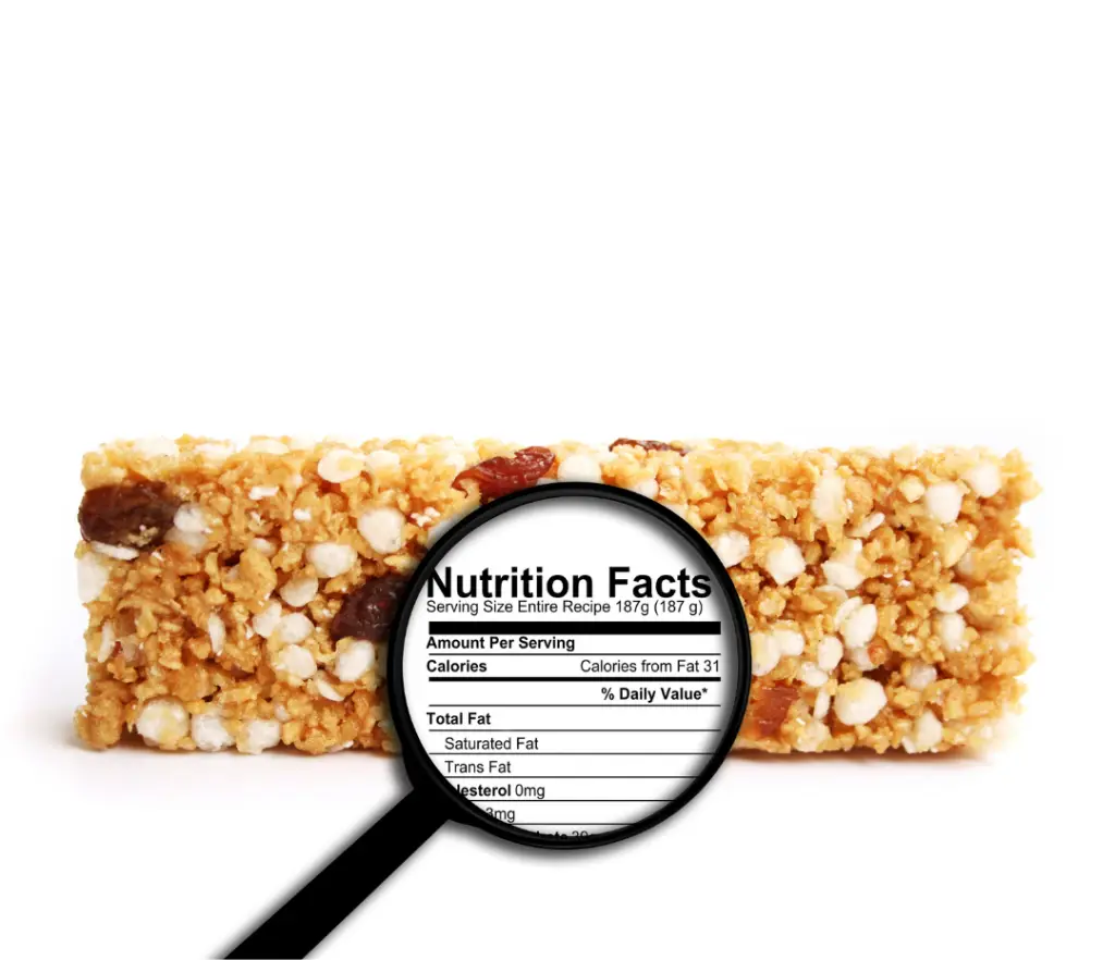 Granola bar with a magnifying glass highlighting the ingredient list, promoting healthy eating in London Ontario by examining processed grains and hidden sugars.